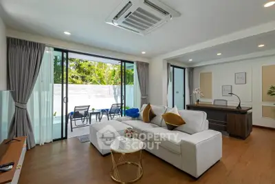 Luxurious living room with pool view and modern decor