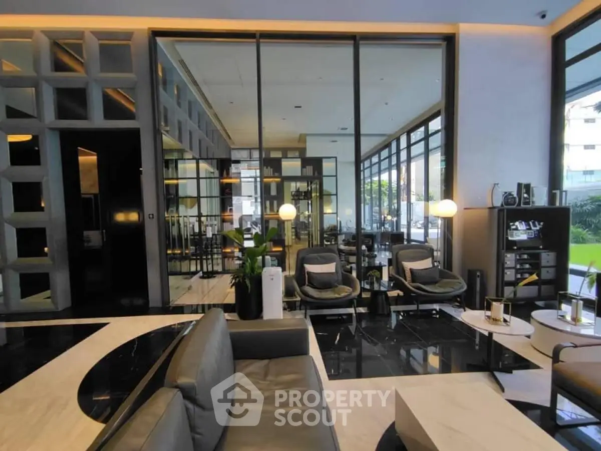 Luxurious modern living room with sleek furniture and large windows offering natural light.