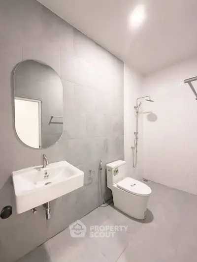 Modern minimalist bathroom with sleek fixtures and neutral tiles