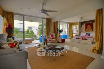 Spacious living room with modern decor and large balcony access