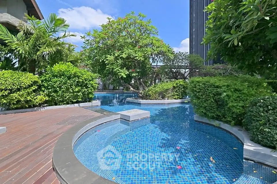 Luxurious outdoor pool area with lush greenery and modern design