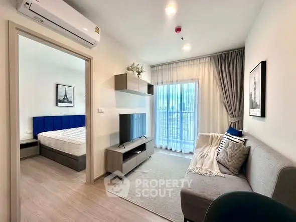 Modern apartment living room with cozy decor and bedroom view