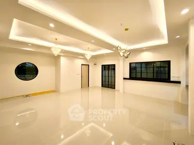 Spacious modern living room with elegant lighting and glossy tile flooring