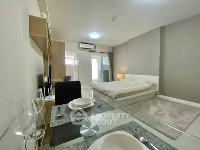 Modern studio apartment with cozy bedroom and dining area