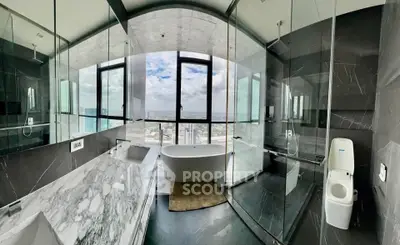 Luxurious bathroom with panoramic city view and elegant marble finishes.
