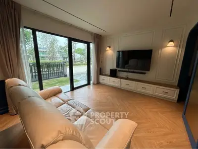 Spacious living room with elegant decor and large sliding glass doors opening to a scenic view.