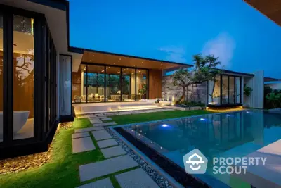 Luxurious modern villa with stunning pool and elegant outdoor lighting at dusk.