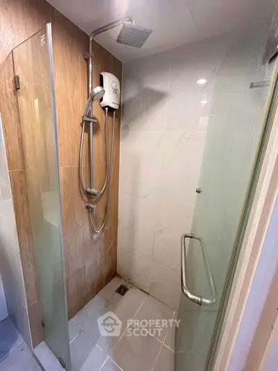 Modern bathroom with glass shower enclosure and sleek fixtures