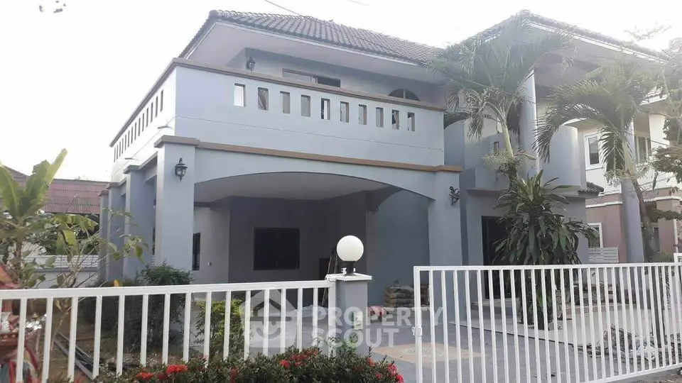Charming two-story house with spacious balcony and lush garden, perfect for family living.