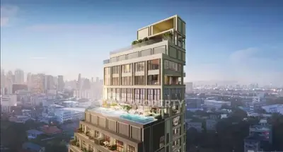 Luxurious high-rise building with rooftop pool and stunning city views.