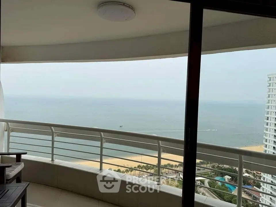 Stunning ocean view from a spacious balcony in a high-rise apartment.