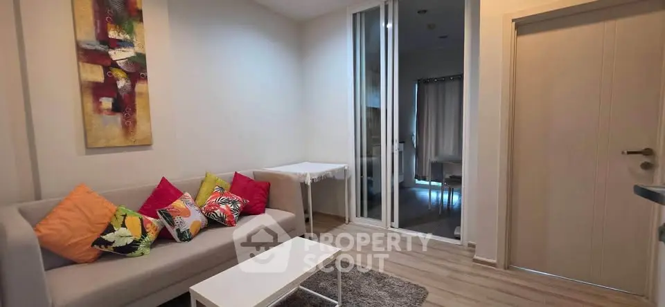 Cozy living room with modern decor and colorful cushions, perfect for relaxation and entertaining guests.