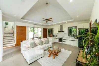 Spacious modern living room with open kitchen and stylish decor
