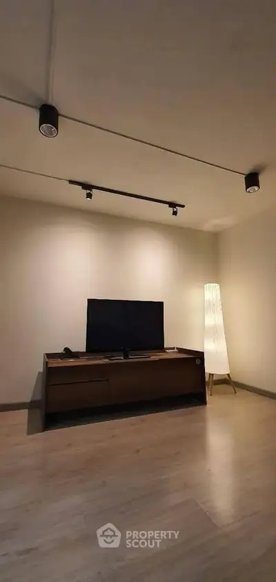 Minimalist living room with modern TV stand and stylish floor lamp