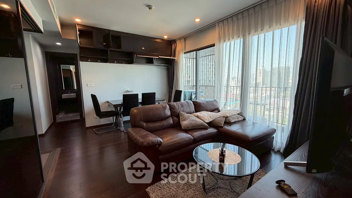 Luxurious living room with leather sofa and city view in modern apartment