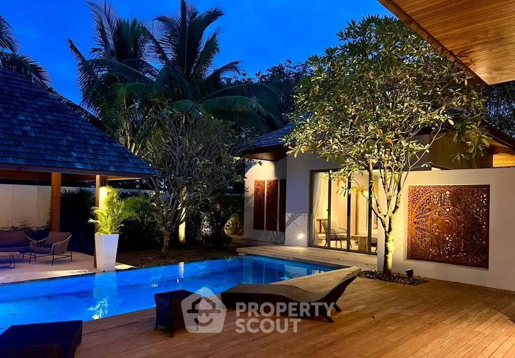 Luxurious tropical villa with private pool and lush garden at dusk.