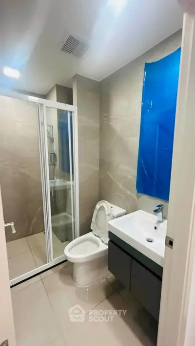 Modern bathroom with sleek shower and contemporary fixtures in a stylish apartment.