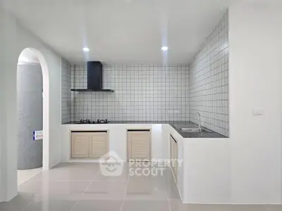 Modern minimalist kitchen with sleek tile backsplash and gas stove