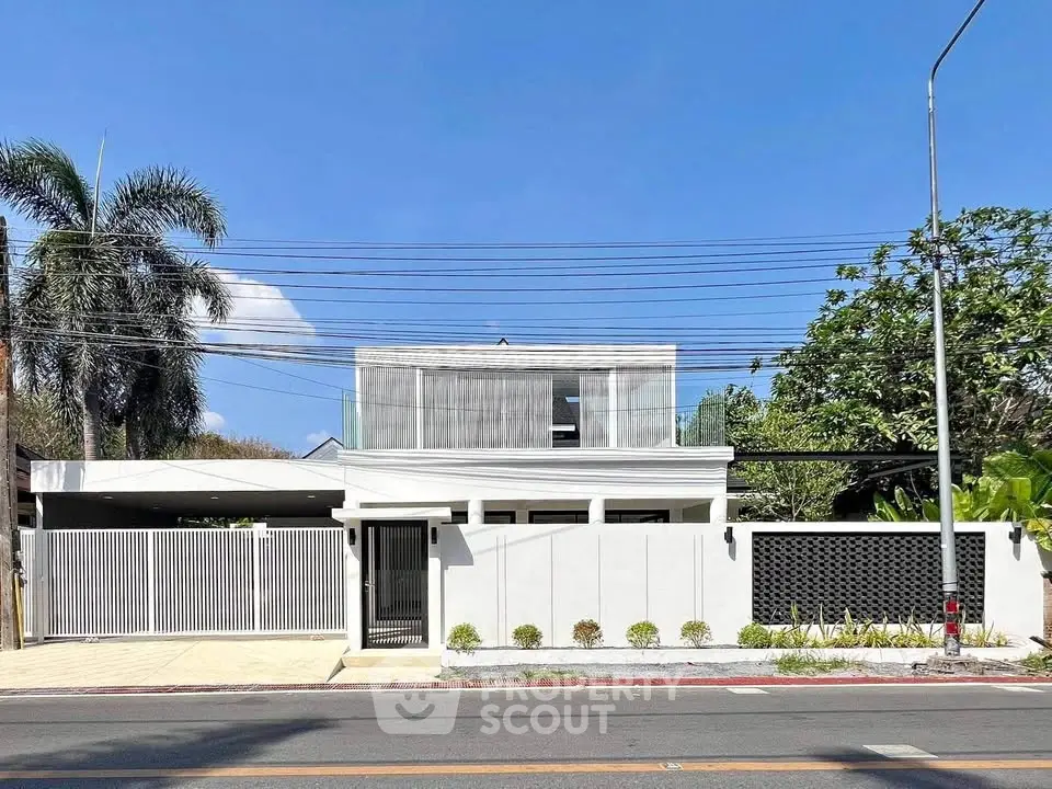 Modern two-story house with sleek design and gated entrance