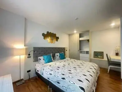 Spacious modern bedroom with stylish decor and ample natural light.