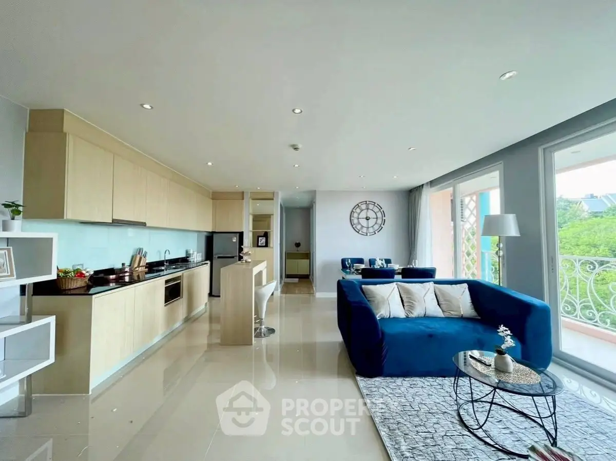 Spacious modern living room with open kitchen and large windows