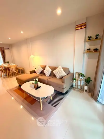 Spacious modern living room with cozy sectional sofa and elegant dining area, perfect for family gatherings.