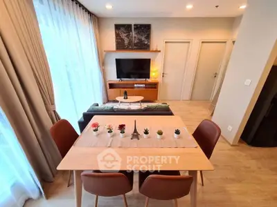 Modern living room with elegant dining area and natural light
