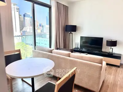Modern living room with city view, featuring sleek furniture and large windows for natural light.
