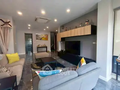 Spacious modern living room with stylish decor and ample natural light.