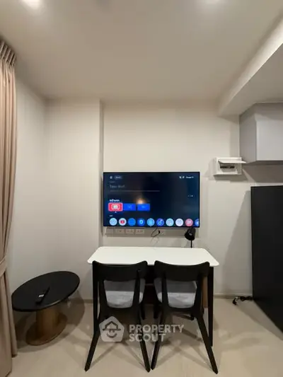 Modern living room with wall-mounted TV and stylish furniture