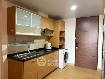 Modern kitchen with wooden cabinets and built-in washing machine