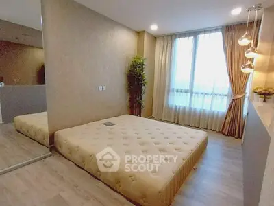 Spacious bedroom with modern decor and large window for natural light