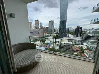 Stunning city view from modern balcony with cozy seating area