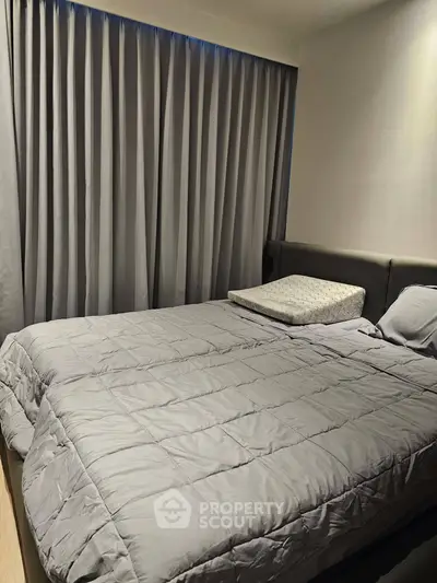 Cozy bedroom with modern decor and soft lighting, featuring a comfortable bed and elegant curtains.