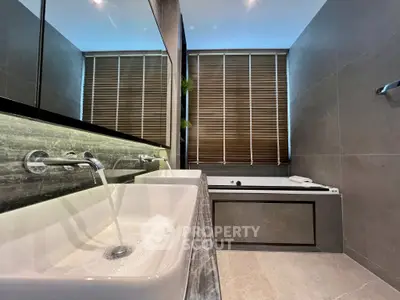 Luxurious modern bathroom with dual sinks and elegant bathtub, featuring sleek design and ambient lighting.