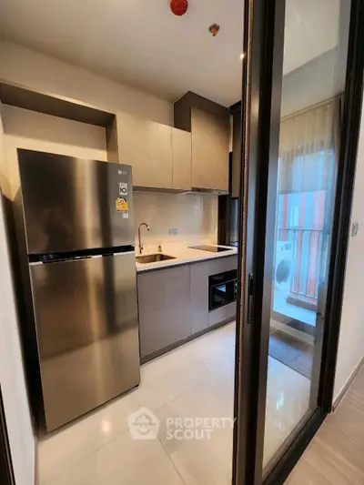 Modern kitchen with sleek appliances and open layout in stylish apartment