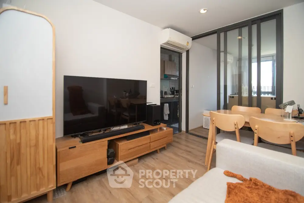 Modern living room with wooden furniture and open kitchen layout