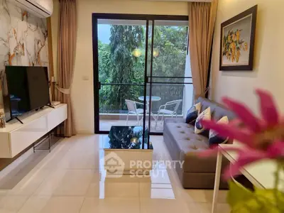 Modern living room with balcony view, featuring sleek furniture and elegant decor.