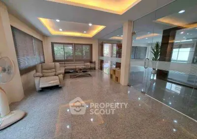 Spacious modern living room with glass walls and elegant lighting