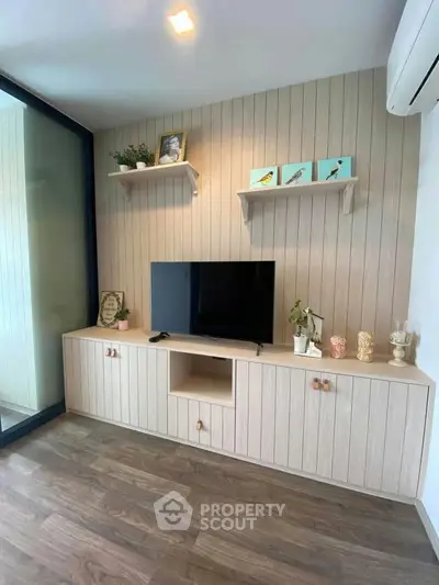 Modern living room with stylish TV unit and wooden paneling, perfect for cozy family gatherings.