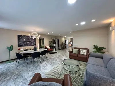 Spacious modern living room with elegant decor and ample natural light.