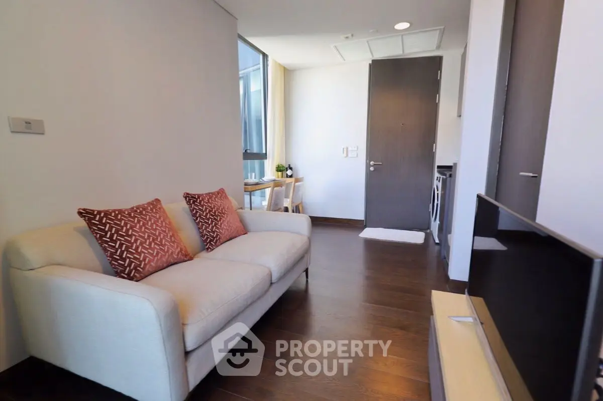 Modern living room with cozy sofa and natural light, perfect for relaxation.