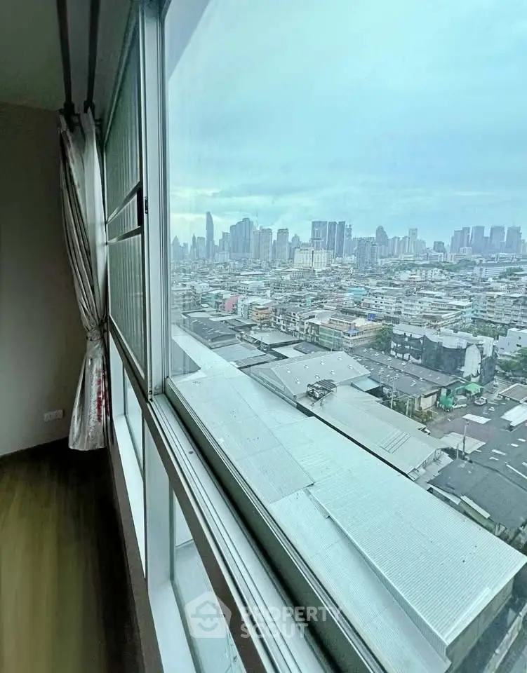 Stunning cityscape view from high-rise apartment window, showcasing urban skyline and expansive horizon.