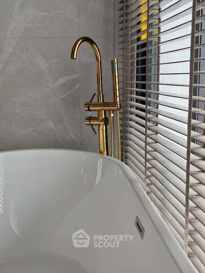 Luxurious bathroom with elegant gold fixtures and modern design