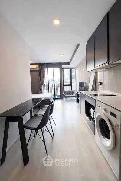 Modern apartment interior with sleek kitchen and city view balcony