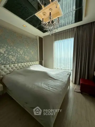 Luxurious bedroom with elegant chandelier and floral accent wall