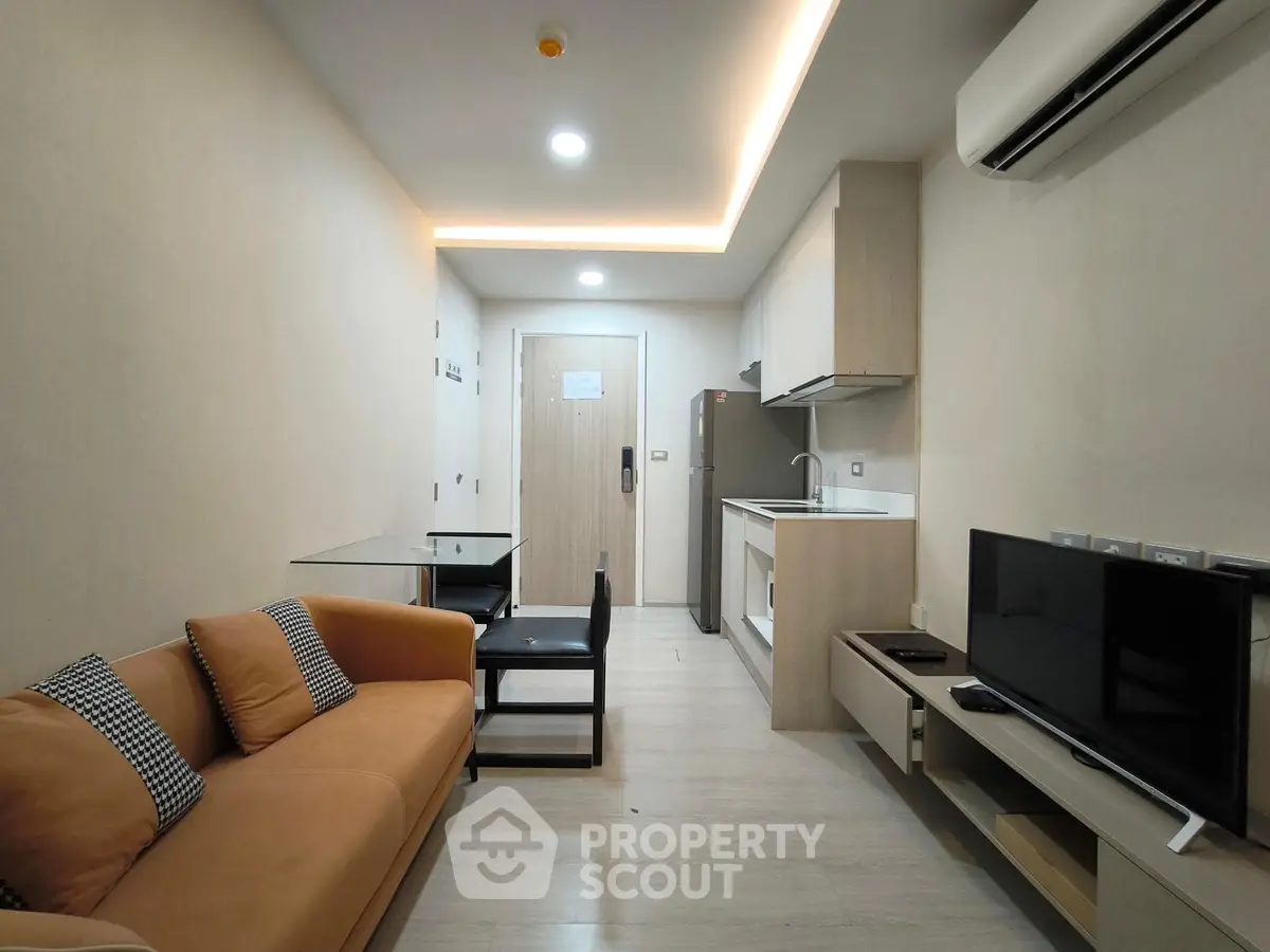 Modern living room with open kitchen layout and cozy sofa