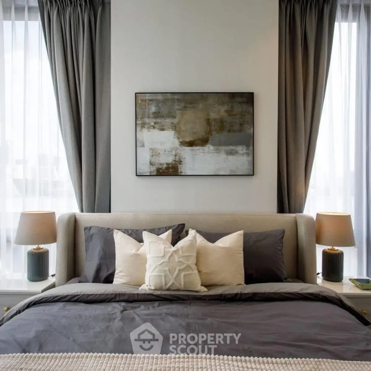 Luxurious bedroom with elegant decor and natural light, featuring stylish bedding and modern art.