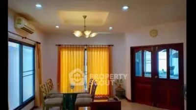 Elegant dining area with warm lighting and modern decor in a cozy home setting.