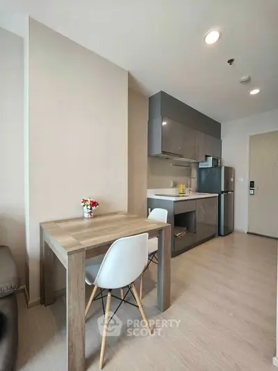 Modern compact kitchen with dining area in stylish apartment